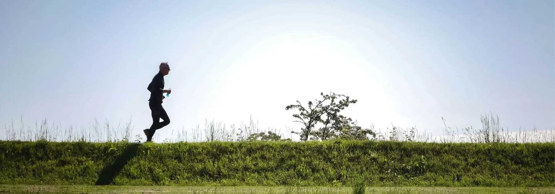 An older adult running outdoors